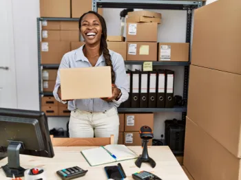 Small business owner managing products and inventory inside a local business workspace