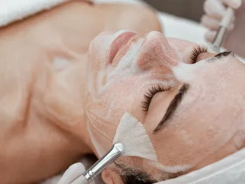 Professional esthetician providing a facial treatment to a client
