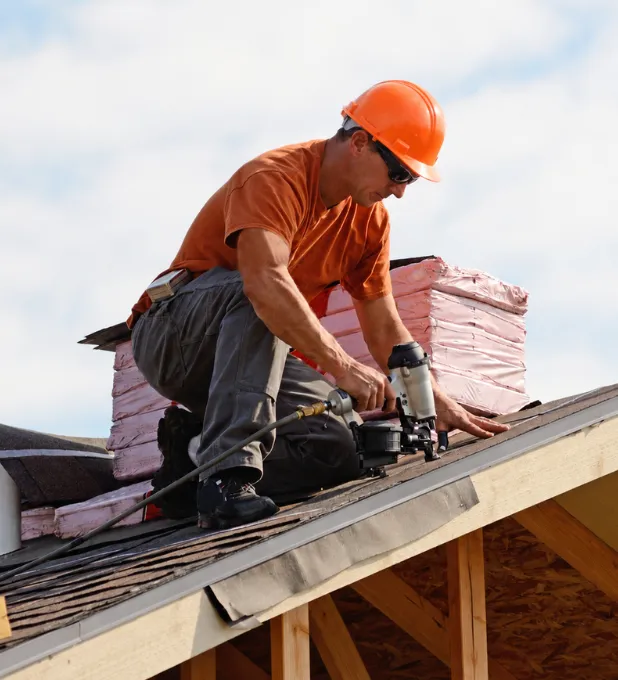 Professional roofer working on a residential roof